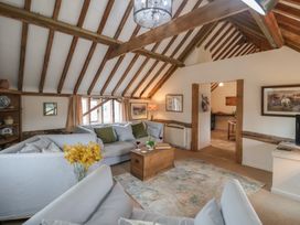 A living room with a sofa and coffee table at The Cow Shed in Chediston near Halesworth