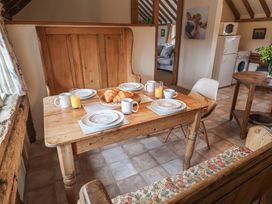 A dining room with a table set for breakfast at The Cow Shed in Chediston near Halesworth