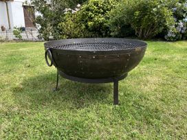 A fire pit on the grass at Riviere House in Hayle
