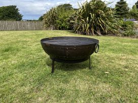 A fire pit on grass at Riviere House in Hayle