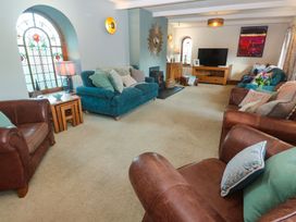A living room with sofas and a television at Riviere House in Hayle