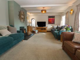 A living room with sofas and a television at Riviere House in Hayle