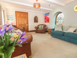 A living room with sofas and armchair at Riviere House Hayle