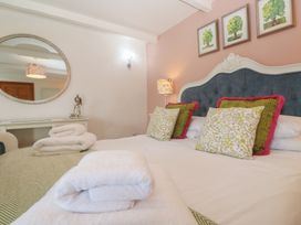 A bed with pillows and towels in a bedroom at Riviere House Hayle