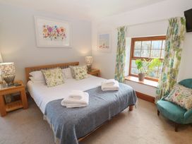 A bedroom with a bed and bedside table at Riviere House in Hayle
