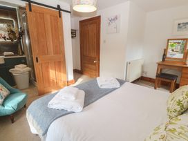 A bedroom with a bed and towels on the bed at Riviere House in Hayle