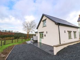 A house with a patio and tree at Y Stabal near Llanilar