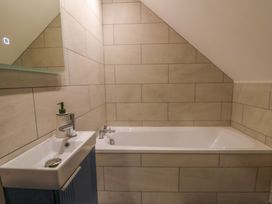 A bathroom with a bath and sink at Y Stabal near Llanilar