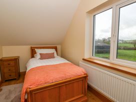 A bedroom with a single bed and window at Y Stabal near Llanilar