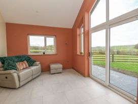 A snug with a sofa and footrest at Y Stabal near Llanilar