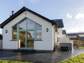 A house with a hot tub on the patio at Y Stabal near Llanilar