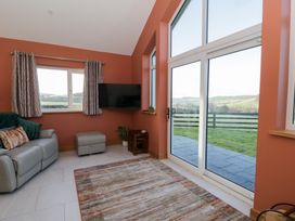 A living room with a sofa and television at Y Stabal near Llanilar