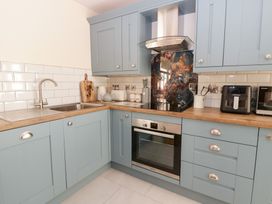 A kitchen with cabinets and appliances at Y Stabal near Llanilar