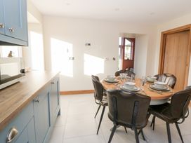 A kitchen with a dining table and chairs at Y Stabal near Llanilar