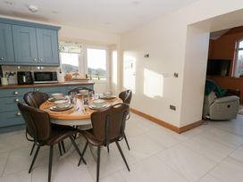 A dining area with a table set for meals at Y Stabal near Llanilar