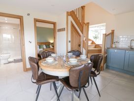 A dining room with a table and chairs at Y Stabal near Llanilar