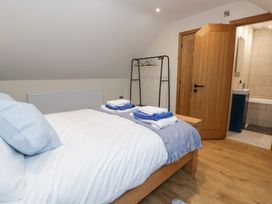 A bedroom with a bed and towels on it at Y Stabal near Llanilar