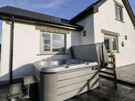 A hot tub next to a house at Y Stabal near Llanilar