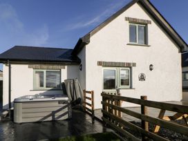 An outdoor area with a hot tub and fence at Y Stabal near Llanilar