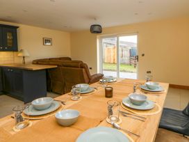 A dining room with a table set for meals at Y Beudy near Llanilar
