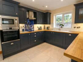 A kitchen with cabinets and appliances at Y Beudy near Llanilar
