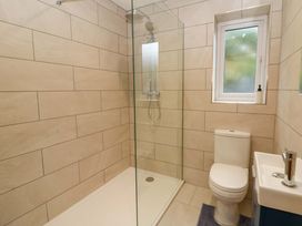 A bathroom with shower, toilet, and sink at Y Beudy near Llanilar