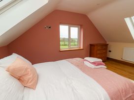 A bedroom with a bed and window at Y Beudy near Llanilar