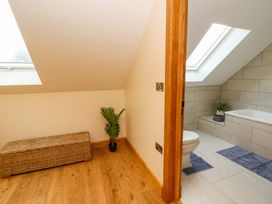 A bathroom with a bathtub and toilet at Y Beudy near Llanilar