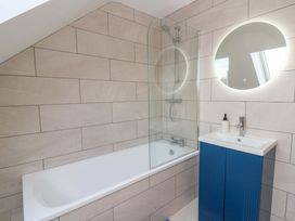 A bathroom with a bathtub and sink at Y Beudy near Llanilar