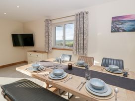 A dining room with a table set for dinner at Beudy near Llanilar
