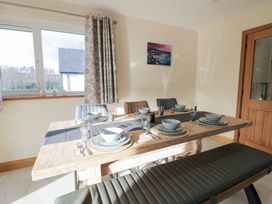 A dining room with a table set for a meal at Beudy near Llanilar