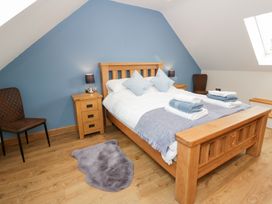 A bedroom with a bed and bedside table at Beudy near Llanilar