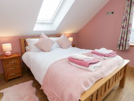 A bedroom with a bed and towels at Beudy near Llanilar
