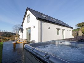 An outdoor space featuring a hot tub and seating at Beudy near Llanilar