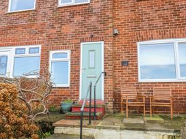 A doorway with steps and chairs outside at Whitby View in Whitby