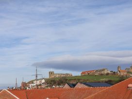 A view of rooftops and hilltop castle at Whitby View in Whitby