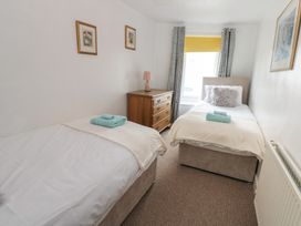 A bedroom with two single beds and a dresser at 1 Eden Cottages in Corby Hill