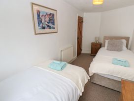 A bedroom with two single beds and a nightstand at 1 Eden Cottages Corby Hill