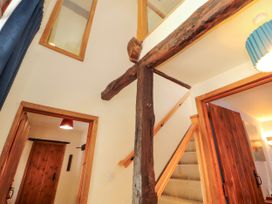 A hallway with stairs and wooden beams at Beck Edge in Braithwaite