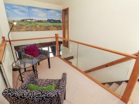 A landing with chairs, a table and wall art at Beck Edge in Braithwaite