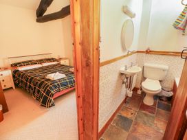 A bedroom with a bed and an adjoining bathroom at Beck Edge in Braithwaite