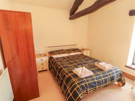 A bedroom with a bed and wardrobe at Beck Edge in Braithwaite