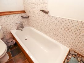 A bathroom with a bathtub and toilet at Beck Edge in Braithwaite