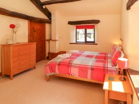 A bedroom with a bed and dresser at Beck Edge in Braithwaite