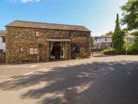 A stone building with windows and a door at Beck Edge in Braithwaite