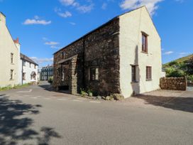A stone building on a road at Beck Edge in Braithwaite