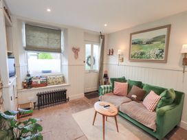 A living room with a sofa and a table at Gosling Cottage in Kendal