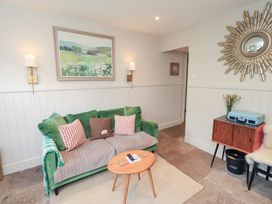 A living room with a sofa and table at Gosling Cottage in Kendal