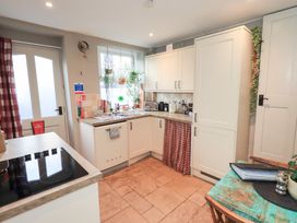 A kitchen with cabinets and a sink at Gosling Cottage in Kendal