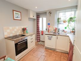 A kitchen with an oven and sink at Gosling Cottage Kendal